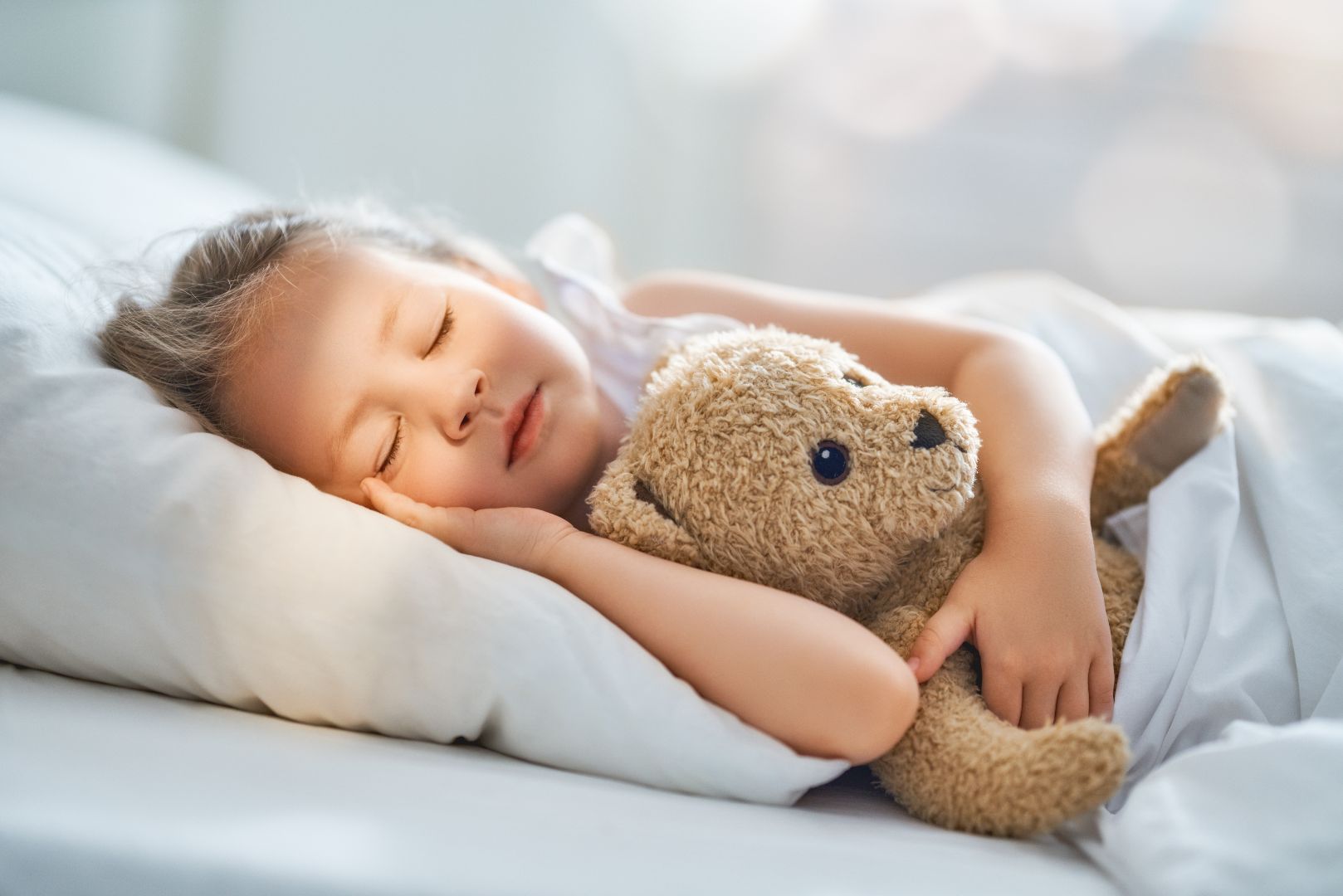 Girl asleep with teddy